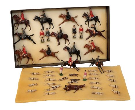 A BRITAINS PAINTED LEAD HUNTING SET including hounds, two foxes, huntsmen on horseback, ladies riding side saddle, huntsmen o