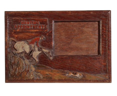 SWAINE &amp; ADENEY: AN EDWARDIAN OAK HUNTING APPOINTMENT HOLDER with a hunting scene carved in relief and painted, signed "E