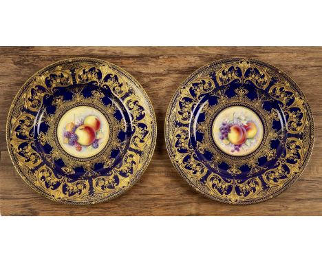 Pair of Royal Worcester porcelain cabinet platesthe central panels with still life of fruit, signed 'P Platt', with blue and 