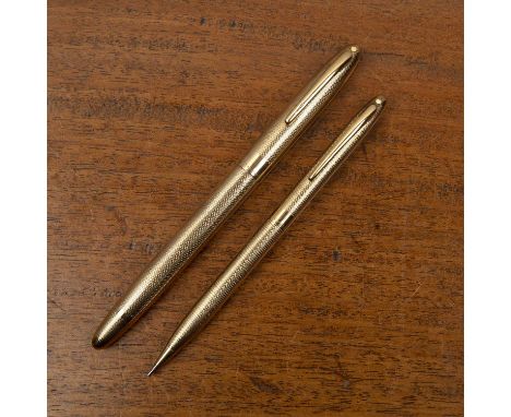 Sheaffers 9ct gold cased pen and pencilboth with engine-turned decoration, 46g approx overall, the fountain pen measures 14cm