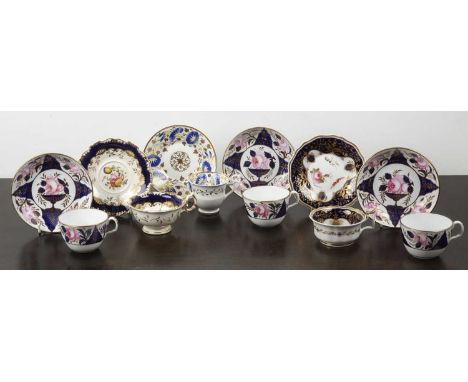 Group of porcelain cups and saucersEnglish, circa 1830/50, including a set of three painted with cobalt blue urns and roses, 