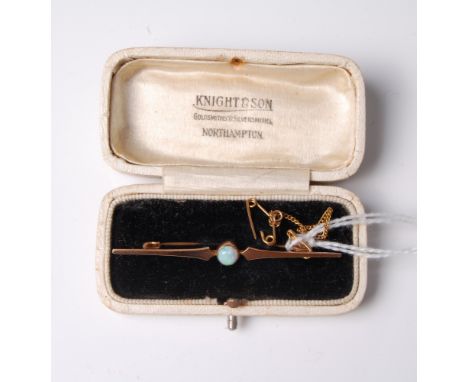 An opal bar brooch, 5.6cm long, stamped 9ct to reverse, with safety chain (2.2g)