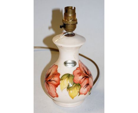 A modern Moorcroft pottery table lamp base on a cream ground with typical tubelined floral decoration, impressed Moorcroft ve