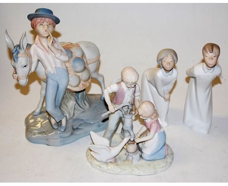A pair of Lladro figures of children, impressed Lladro Made in Spain verso; together with two other Spanish porcelain figures