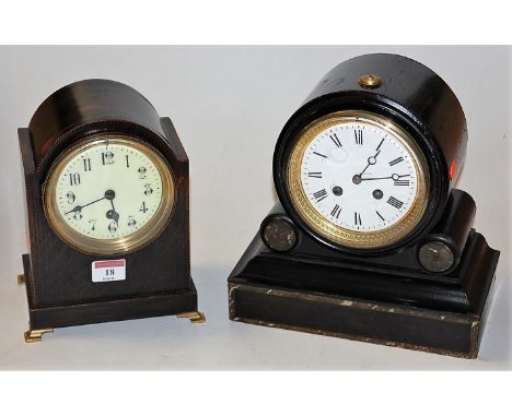 A late Victorian faux marble ebonised drum shaped mantel clock having enamelled dial with Roman numerals and eight day moveme