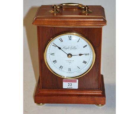A modern walnut cased mantel clock, having convex enamel dial with Roman numerals, signed Knight & Gibbins of London, having 