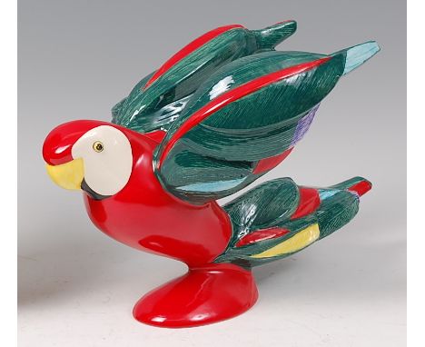 A Goebel painted and glazed ceramic model of a Scarlet Macaw parrot, in flying pose, with primary red and green colour scheme