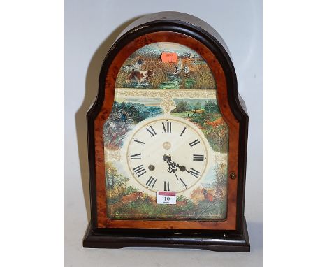 A reproduction walnut cased mantel clock, the dial printed with various hunting scenes, having Roman numerals and eight day m