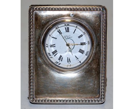 A modern Carr of London silver mounted easel mantel clock having a enamelled dial with Roman numerals signed Carr, Piccadilly