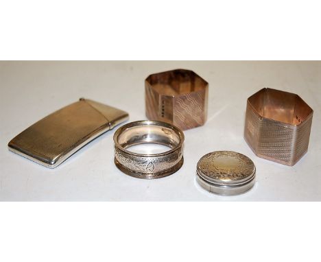 A George V silver calling card case of hinged rectangular form together with a silver dressing table jar top only, three silv