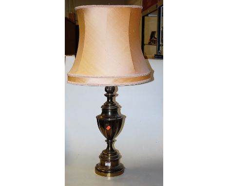 A large lacquered brass table lamp of urn shape having a silk shade