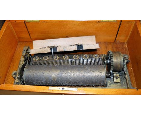 A circa 1900 walnut and marquetry inlaid music box, the associated movement playing 6 airs (several teeth broken, condition p