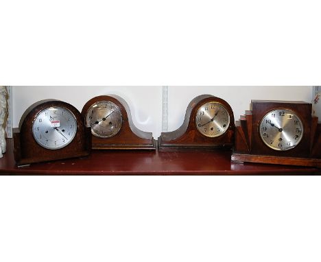 A 1930s oak cased mantel clock, having silvered dial with Arabic numerals and eight day movement; together with three other s