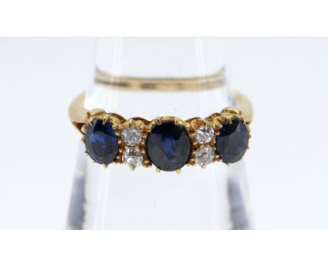 18CT GOLD SAPPHIRE &amp; DIAMOND RING, the three sapphires separated by two pairs of diamonds, claw set, ring size O / P, 2.9