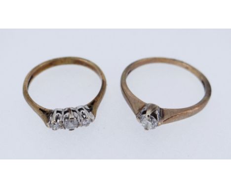 TWO 9CT GOLD DIAMOND RINGS comprising one single stone (stamped 0.30cts) and one three stone, 3.6gms overall, both in ring bo