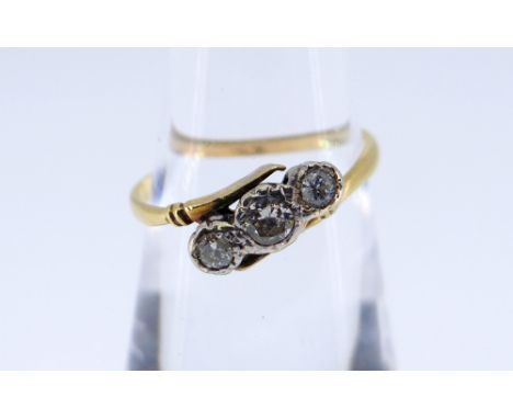 YELLOW METAL THREE STONE DIAMOND RING, illusion set on twist shank, 0.2cts overall approximately, ring size K, 1.9gms, in hea