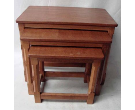Robert 'Mouseman' Thompson of Kilburn, a nest of three oak Occasional Tables, rectangular tops each with adzed finish, joined
