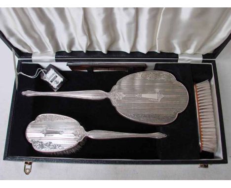 A mid 20th century four piece silver mounted Dressing Table Set consisting of a brush, hand mirror, comb and clothes brush, e