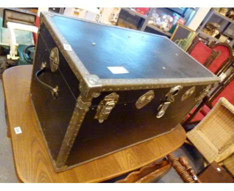 Large black luggage trunk with metal edges