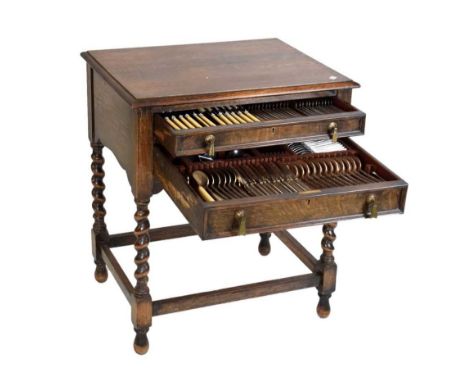 1930s canteen of 'Celtic' pattern cutlery of twelve settings in an oak Jacobean style floor standing case