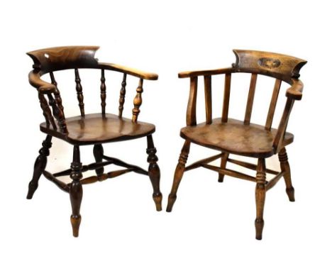 Two smokers bow chairs, the elm seats raised on turned tapered supports