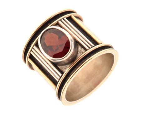 White metal ring, unmarked, set an oval faceted garnet, 1.8cm wide, size O approx, 12.4g gross approx