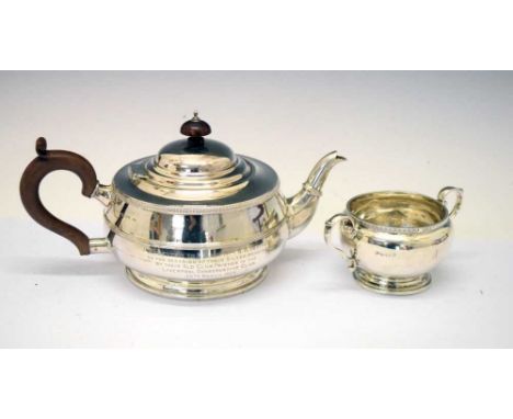 George V silver two-piece tea service comprising teapot and sugar bowl, with scroll handles and presentation inscription, tea