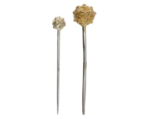 Two 16th century Tudor silver gilt hair pins, both with hollow spherical heads, the first designed as three twisted filigree 