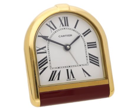 Cartier. A gilt metal desk timepiece with alarm, Ref. 6602, Tortue, circa 1990. Movement: quartz. Dial: white, Roman numerals