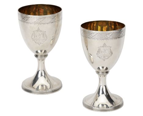 A matched pair of George III silver wine goblets, each engraved with a band of leaf decoration, a cursive initial ‘N’ within 