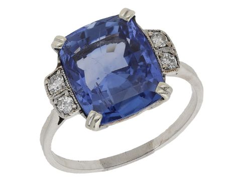 An Art Deco Sri Lankan sapphire and diamond ring, the cushion-shaped sapphire, weighing 7.87 carats, with two transitional-cu