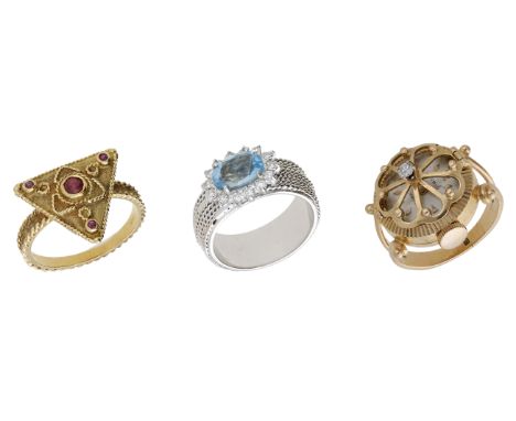 Three gem-set rings, comprising a triangular ruby-set ring, an aquamarine and diamond cluster ring, both with applied ropetwi