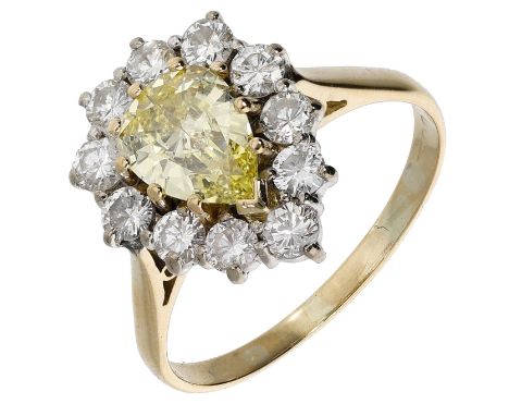 A diamond cluster ring, set with a pear-shaped diamond of yellow tint, weighing 0.84 carat, within a surround of brilliant-cu