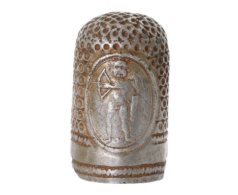 A late 17th century silver thimble, hand punched, with two oval medallions to the sides, the first portraying Cupid with bow 
