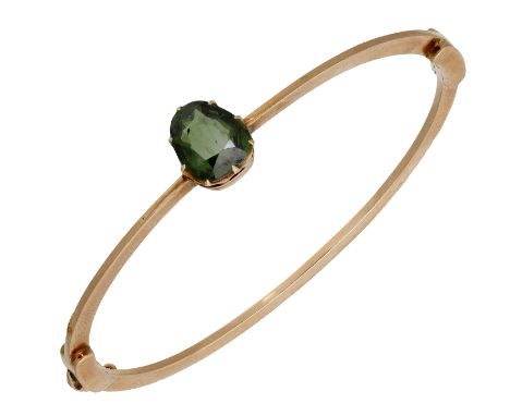 A tourmaline bangle, the hinged bangle of knifewire form and set to the front with a mixed-cut green tourmaline, inner dimens