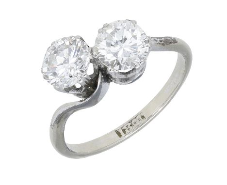 A diamond two stone ring, of crossover design, each side set with a brilliant-cut diamond, stamped ‘18CT’, total diamond weig