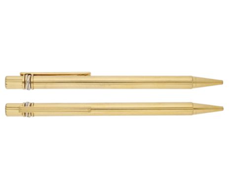 A bicoloured gold plated ‘Must de Cartier’ ballpoint pen by Cartier, of reeded design, signed, serial number C88533, with ori