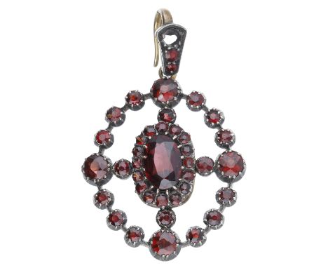 A late 19th century garnet pendant, of target design, set throughout with vari-cut garnets, mounted in silver and gold, (one 