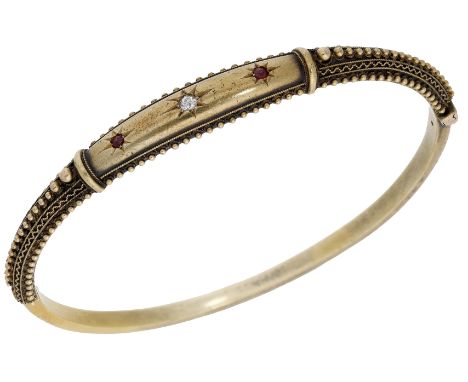 A late 19th century ruby and diamond bangle, the hinged bangle of tapered form, the upper section set with an old brilliant-c