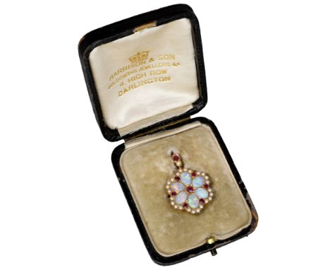 An early 20th century opal, ruby and seed pearl pendant, of flowerhead design, the opal cabochons spaced by circular-cut rubi