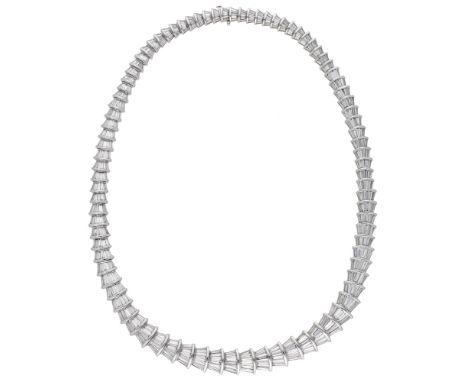 A diamond collar, designed as a continuous series of interlocking fan-shaped links, set throughout with tapered baguette-cut 