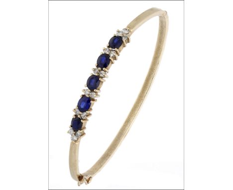 A sapphire and diamond bangle,  set to the front with oval-cut sapphires spaced by pairs of brilliant-cut diamonds, inner dia