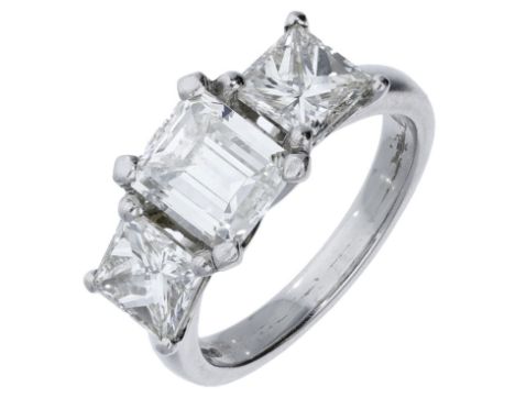 A diamond three stone ring, set with a step-cut diamond with a princess-cut diamond to either side, mounted in platinum, UK h