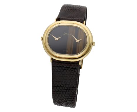 DeLaneau. A gold oval dual dial wristwatch, circa 1980. Movement: dual manual winding movements, 17 jewels. Dial: tiger’s eye