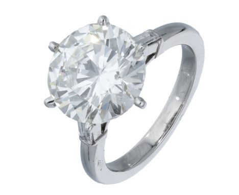 A diamond ring, the brilliant-cut diamond, weighing 6.02 carats, between baguette-cut diamonds shoulders, ring size N.  £20,0