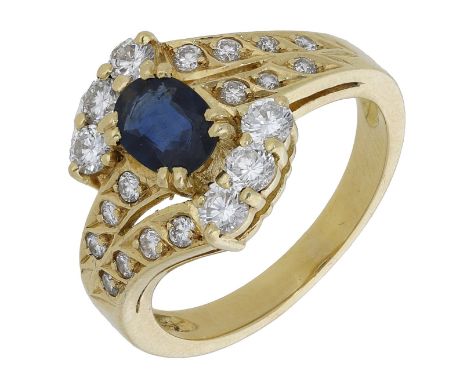 A sapphire and diamond ring, the oval mixed-cut sapphire claw-set between brilliant-cut diamond trios and similarly-set cross