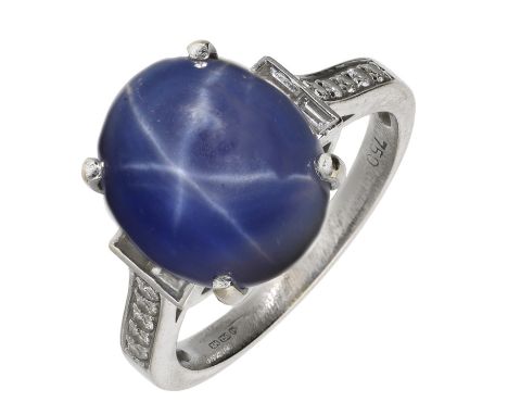 A synthetic star sapphire and diamond ring, the oval synthetic star sapphire cabochon between baguette and brilliant-cut diam