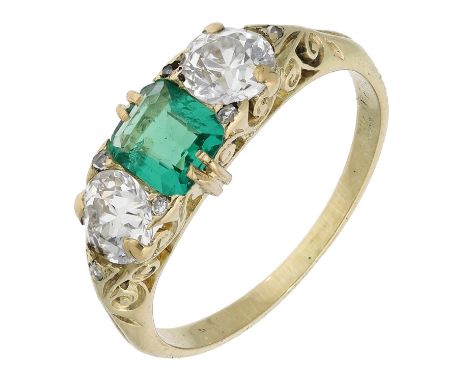 An emerald and diamond ring, the octagonal-cut emerald between two old-cut diamonds, within scrollwork gallery setting, total
