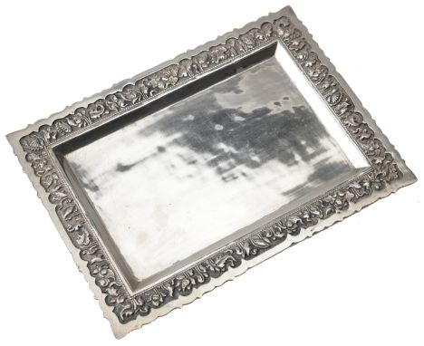 A mid 20th century Indonesian Yogya silver tray, the rectangular shallow tray with repoussé foliate decoration to the border 