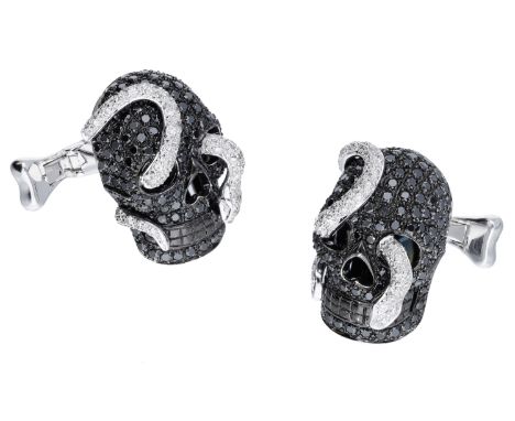 A pair of diamond skull and serpent cufflinks by Theo Fennell, 2007, the skulls pavé set with brilliant-cut treated black dia